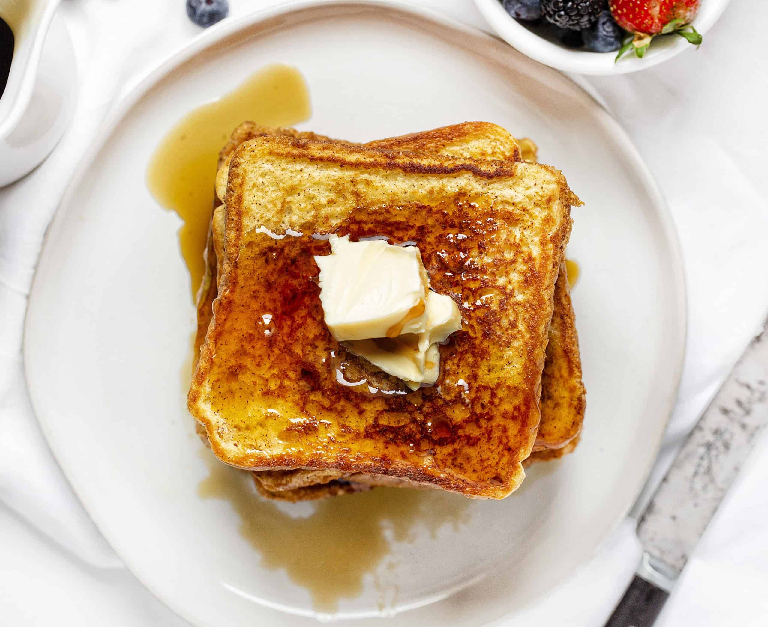 Plate of French Toast Covered in Syrup and Butter. 