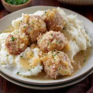 Plate of Ham Balls Over Mashed Potatoes.
