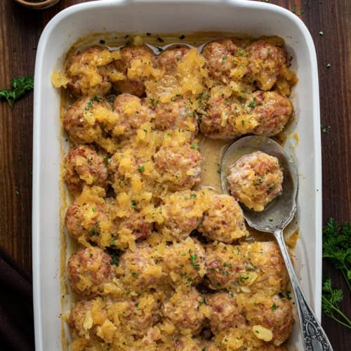 Pan of Ham Balls on a Dark Table from Overhead.