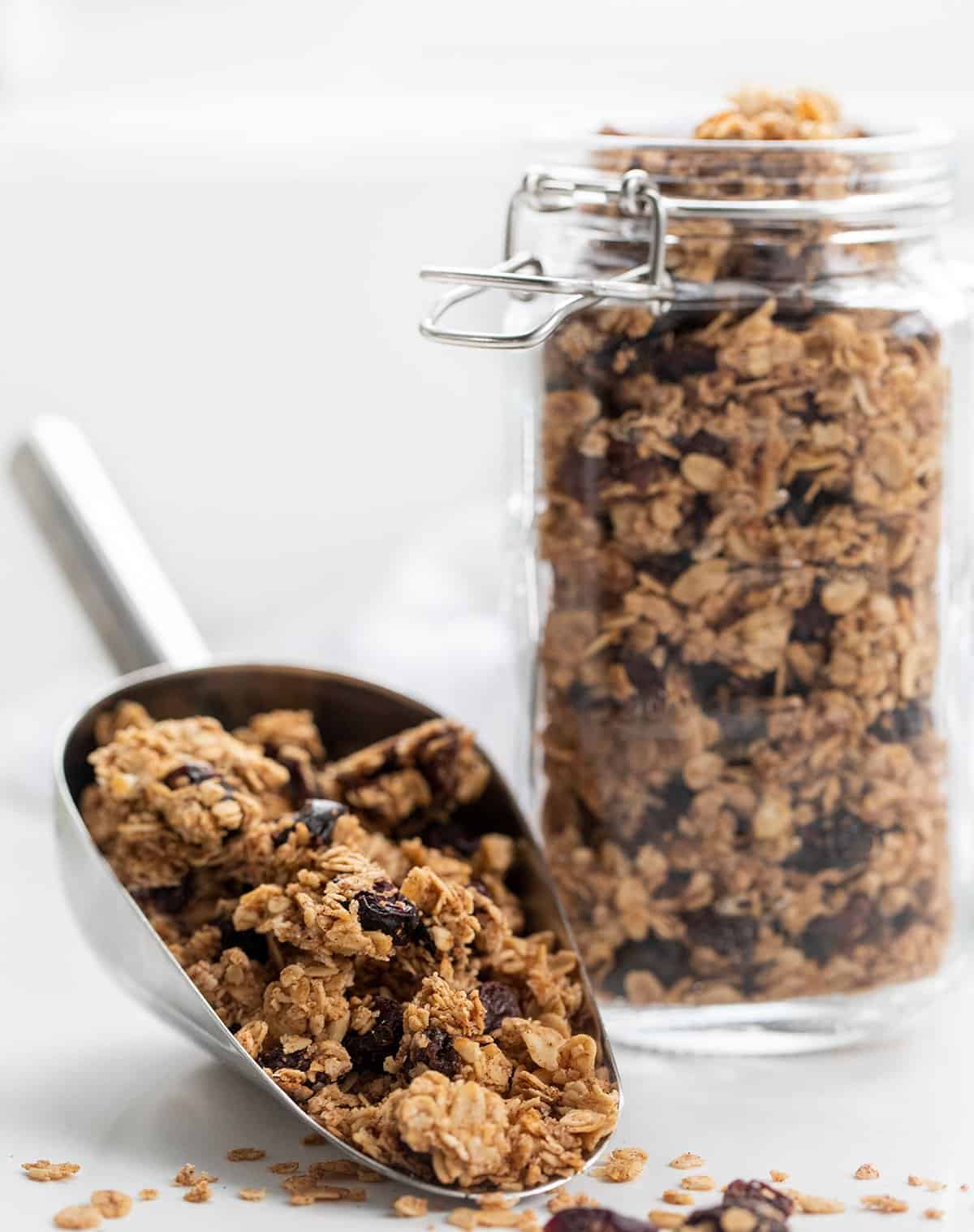 Jar of Homemade Granola and Spoonful Spilling Out