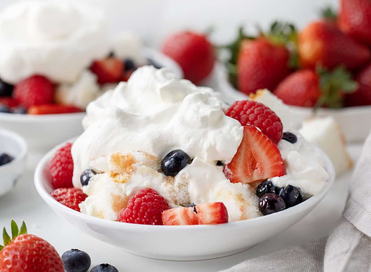 Bowl of Very Berry Trifle showing the tender angel food cake and fruit.