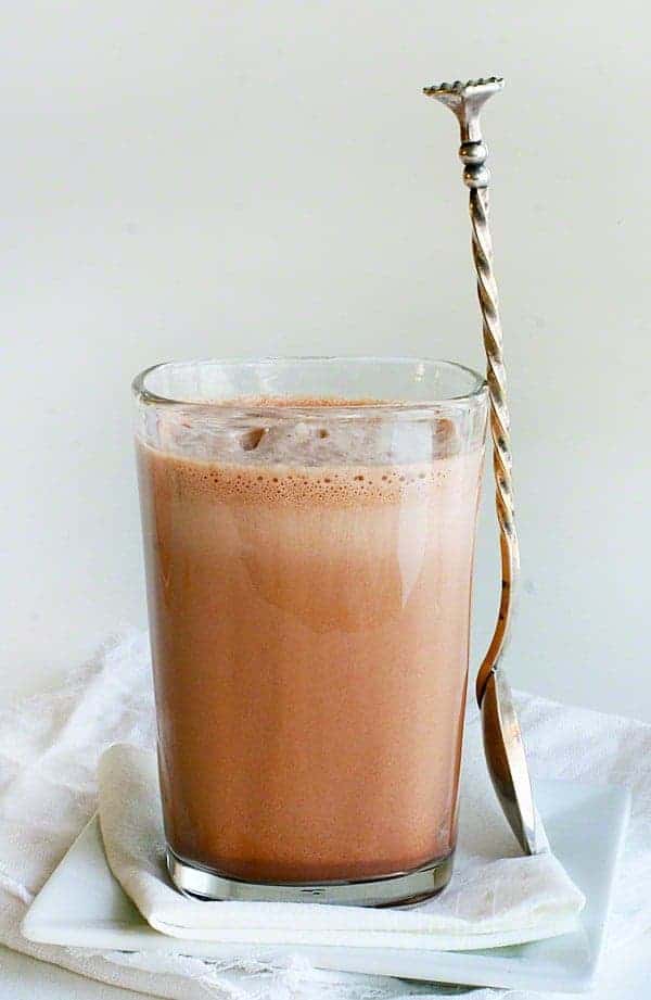Homemade Chocolate Milk Recipe in a Glass with Spoon resting on glass