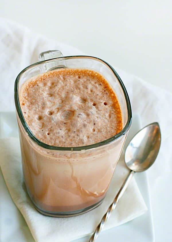 Glass of Frothy Chocolate Milk with Spoon