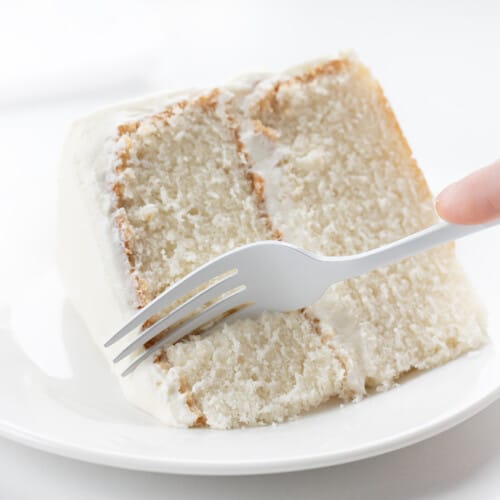 Fork Taking a Piece of White Cake .