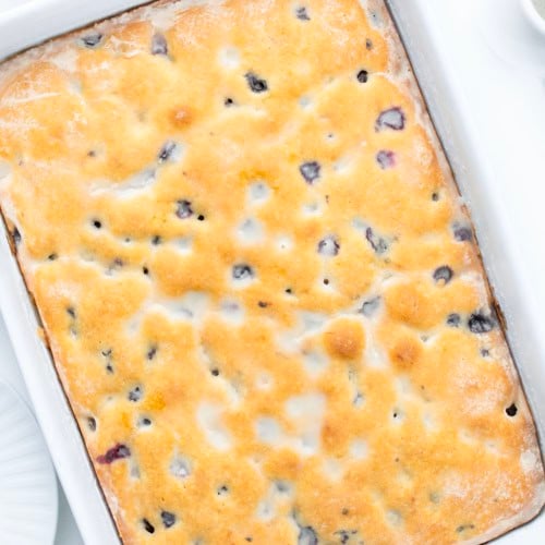 Looking down on a Blueberry Breakfast Cake on a white table.