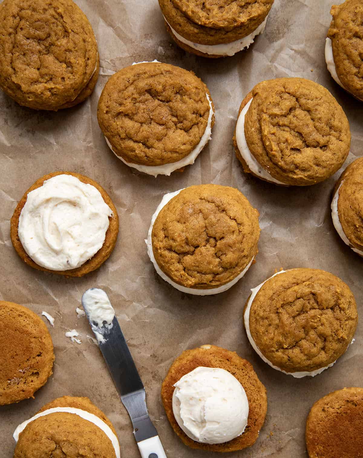 Some assembled and some still needing the top cookie for Pumpkin Sandwich Cookies with Brown Butter Buttercream.