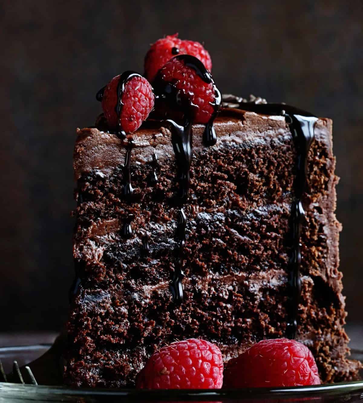 Piece of Chocolate Cake on Plate with Raspberries