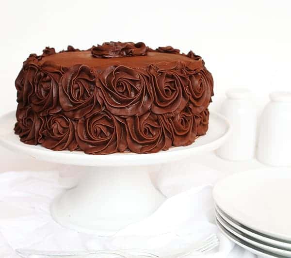 The Perfect Chocolate Cake Recipe and Perfect Chocolate Buttercream on White Cake Stand