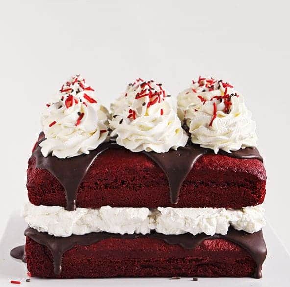 Red Velvet Cake Covered in Rich Chocolate Ganache and Topped with Peppermint Whipped Cream #cake #Christmas
