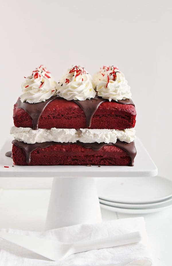 Red Velvet Cake Covered in Rich Chocolate Ganache and Topped with Peppermint Whipped Cream #cake #Christmas 