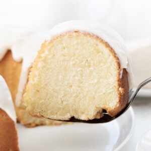 Picking up a Piece of Vanilla Bundt Cake with a Cake Server.