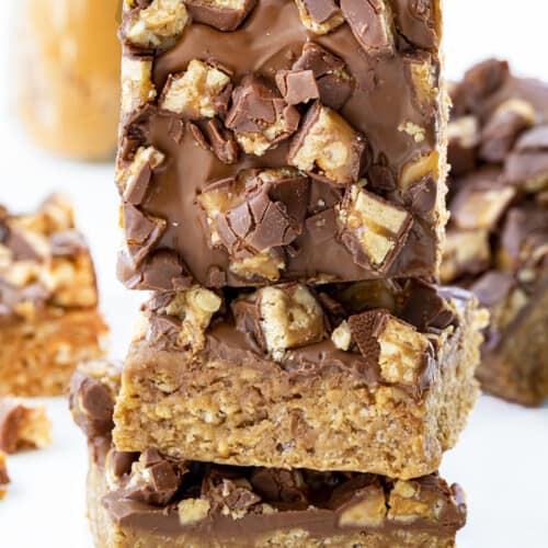Stacked Snickers Special K bars Showing Top of One Bar. Dessert, Scootchero Bars, SpecialK Bars, bars, bar recipes, scootch-er-oo bars, snicekrs bars, kid snacks, chocolate, peanut butter, butterscotch, recipes, i am baker, iambaker.