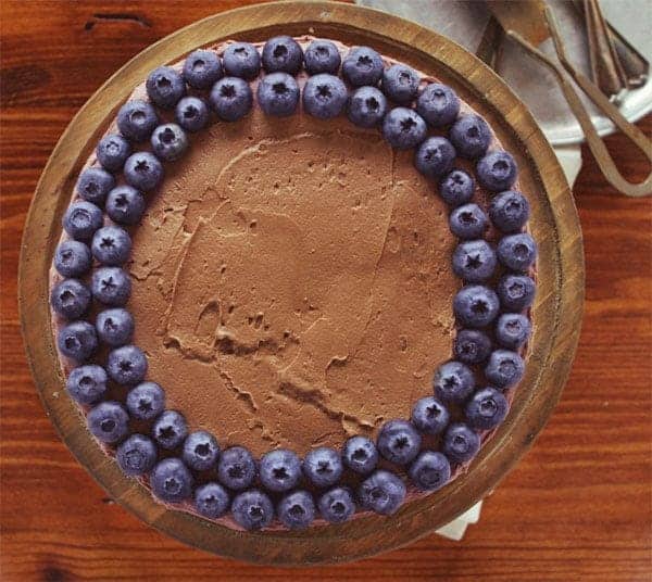 White Zucchini Cake Recipe with Chocolate Frosting and Blueberries Lined up Around Top