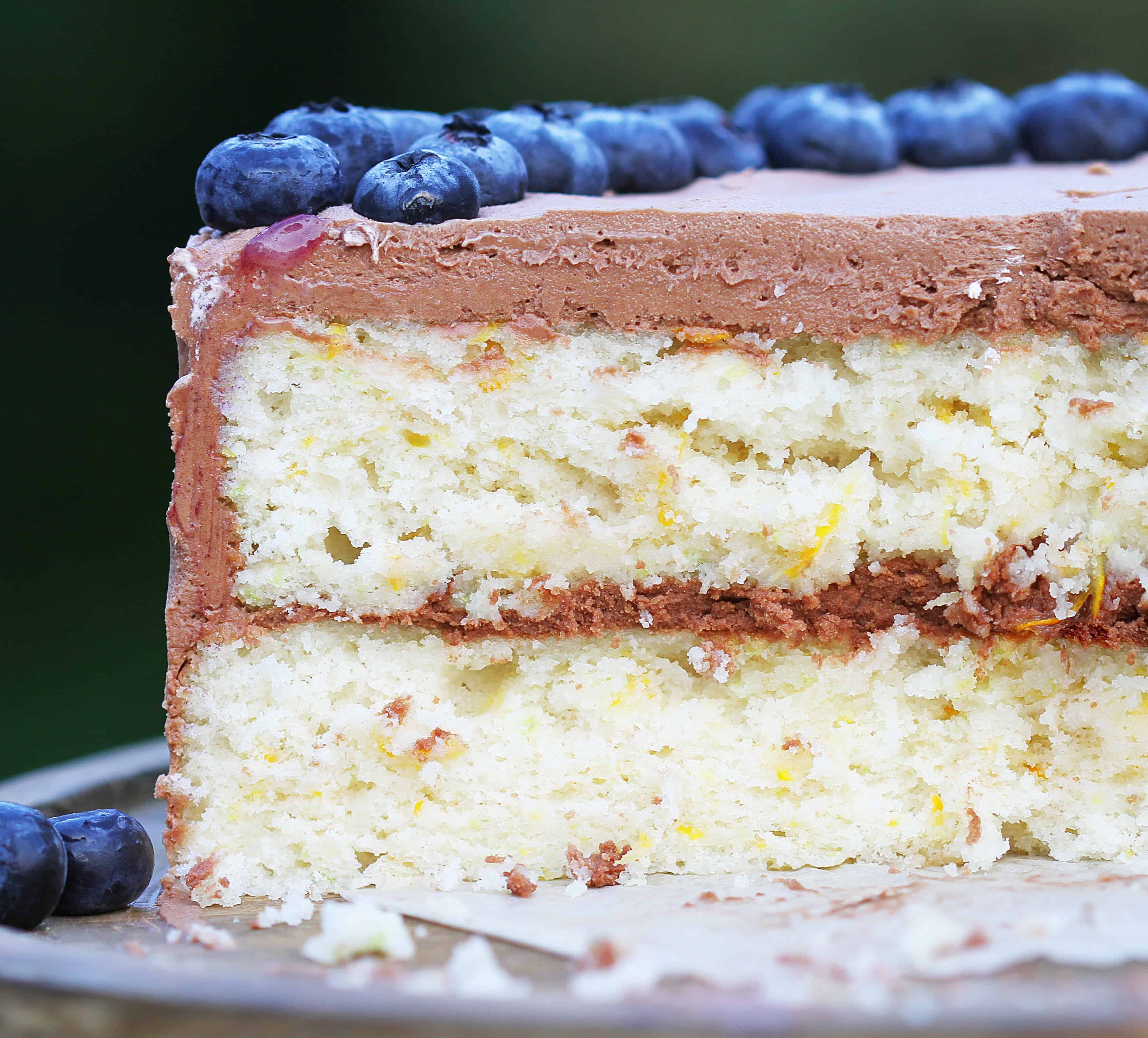 White Zucchini Cake on Platter Outside with Chocolate Frosting