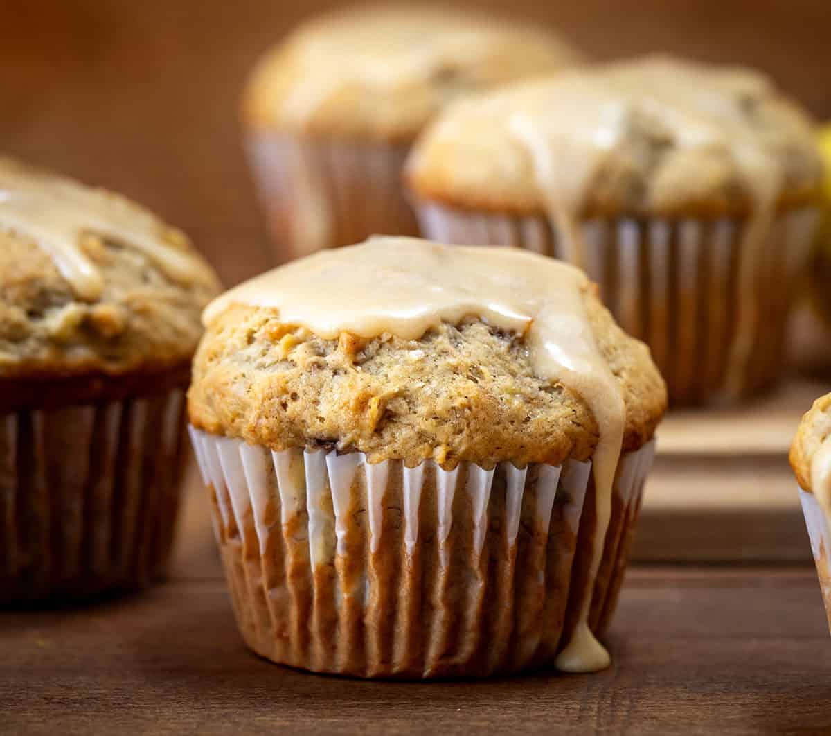 Banana Muffins With Vanilla Caramel Glaze on a wooden table close up. 