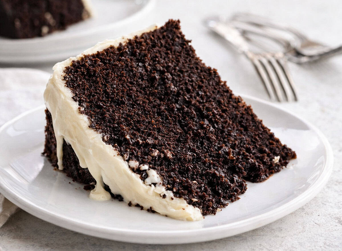 Piece of moist Chocolate Beer Cake on a white plate.