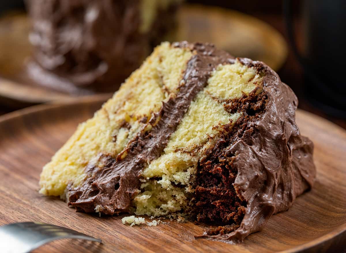 Piece of Marble Cake on a Plate with a Bite Removed Showing Inside Texture.