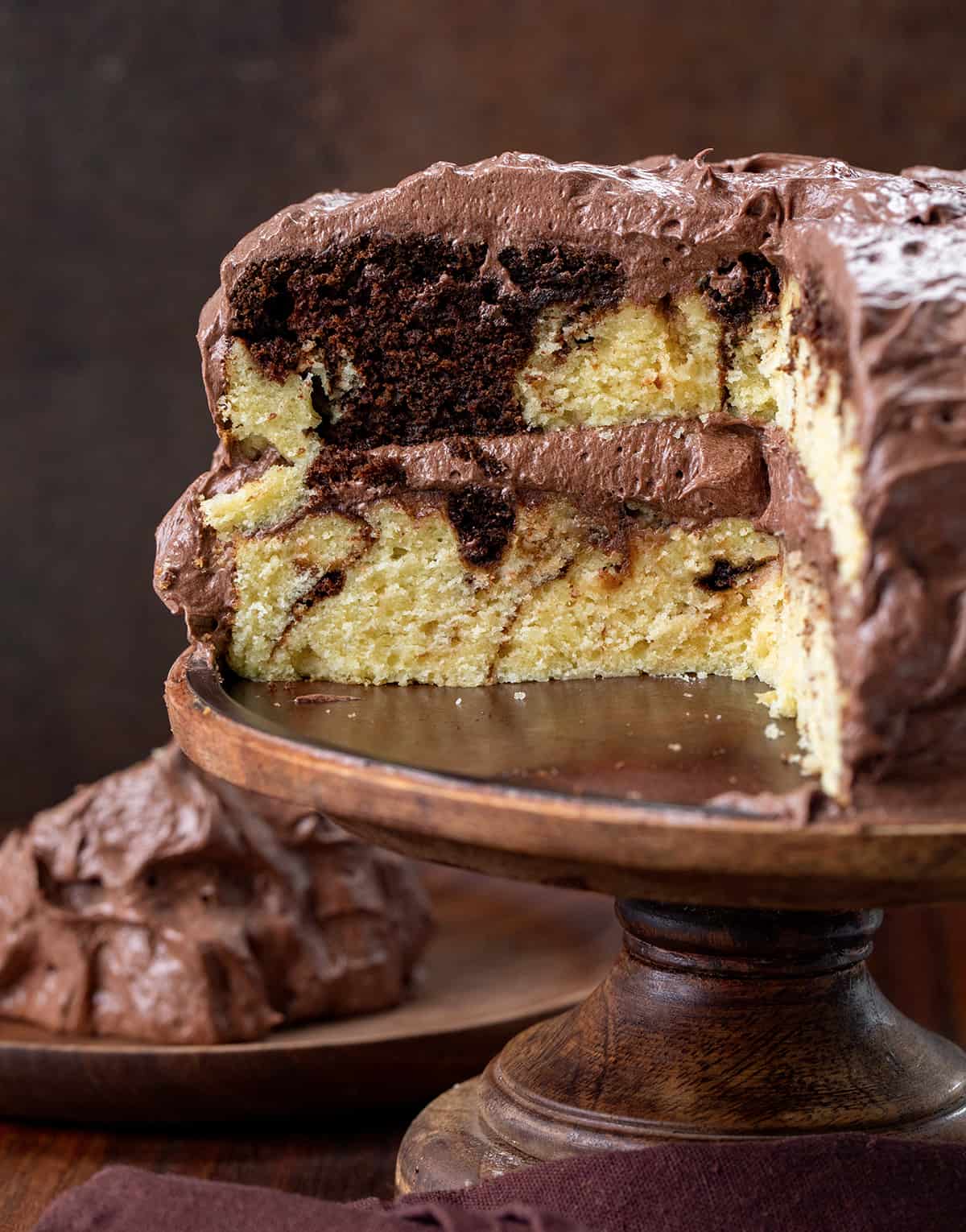 Marble Cake on a Cake Stand with Some Pieces Removed so Inside is Visible.