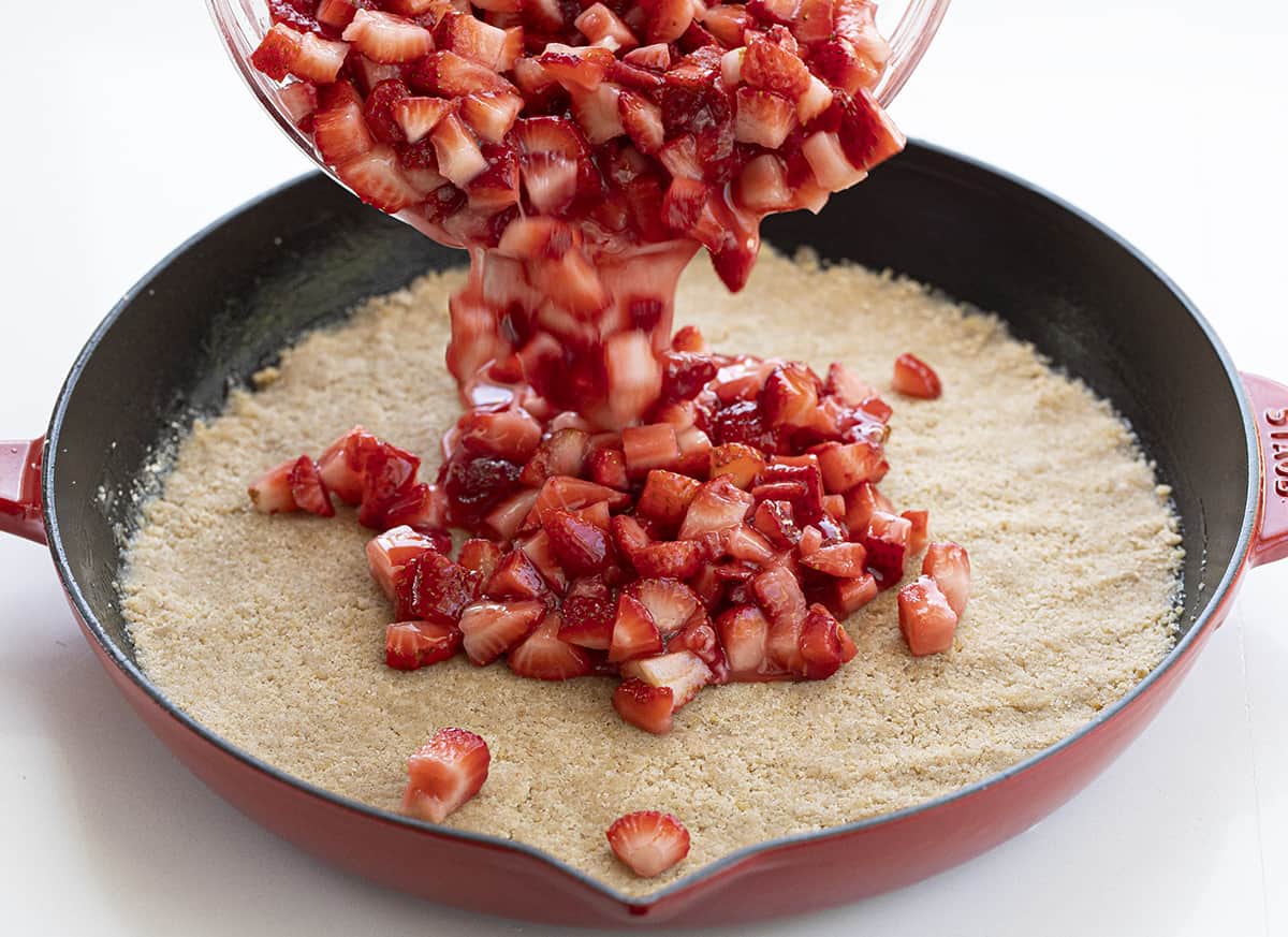 Adding Strawberries to Skillet Strawberry Crumble