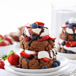 Chocolate Strawberry Shortcakes on white plates pm a white table.