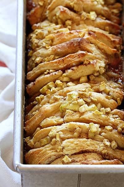 Zucchini Pull-Apart Bread in long pan with towel next to it