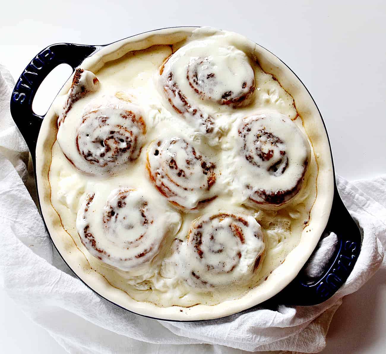 Baked Pumpkin Cinnamon Rolls with whipped cream cheese frosting