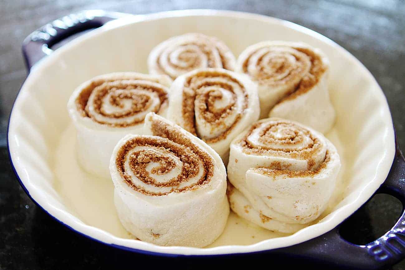 Plate of pumpkin cinnamon rolls ready to be baked