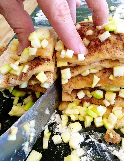 overhead image showing cutting through stacks of zucchini pull apart bread