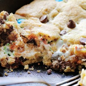 This decadent Skillet Cookie takes Ooey Gooey to a new level!