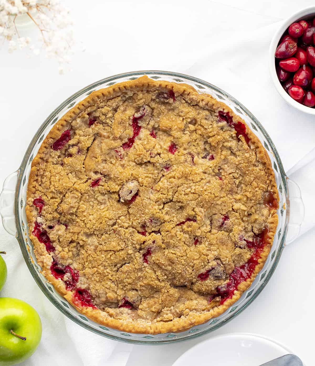 Baked French Apple Cranberry Pie with Apples and Cranberries Near it. Dessert, Baking, Pies, French Pies, Cranberry Pie, Apple Pie, Crumble for Pie, Homemade Pie, Holiday Pie, Christmas Pie, Thanksgiving Pie, Thanksgiving Dessert, Christmas Dessert, i am baker, iambaker