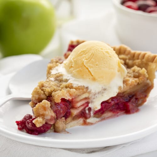 Slice of French Apple Cranberry Pie with Ice Cream Melting and a Spoon to Eat With. Dessert, Baking, Pies, French Pies, Cranberry Pie, Apple Pie, Crumble for Pie, Homemade Pie, Holiday Pie, Christmas Pie, Thanksgiving Pie, Thanksgiving Dessert, Christmas Dessert, i am baker, iambaker