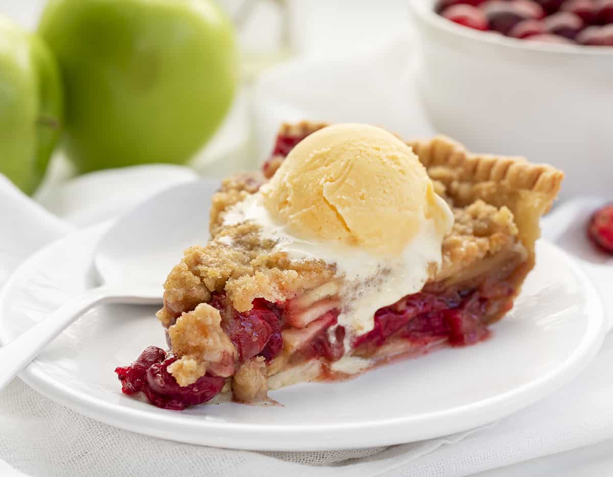 Slice of French Apple Cranberry Pie with Ice Cream Melting and a Spoon to Eat With. Dessert, Baking, Pies, French Pies, Cranberry Pie, Apple Pie, Crumble for Pie, Homemade Pie, Holiday Pie, Christmas Pie, Thanksgiving Pie, Thanksgiving Dessert, Christmas Dessert, i am baker, iambaker