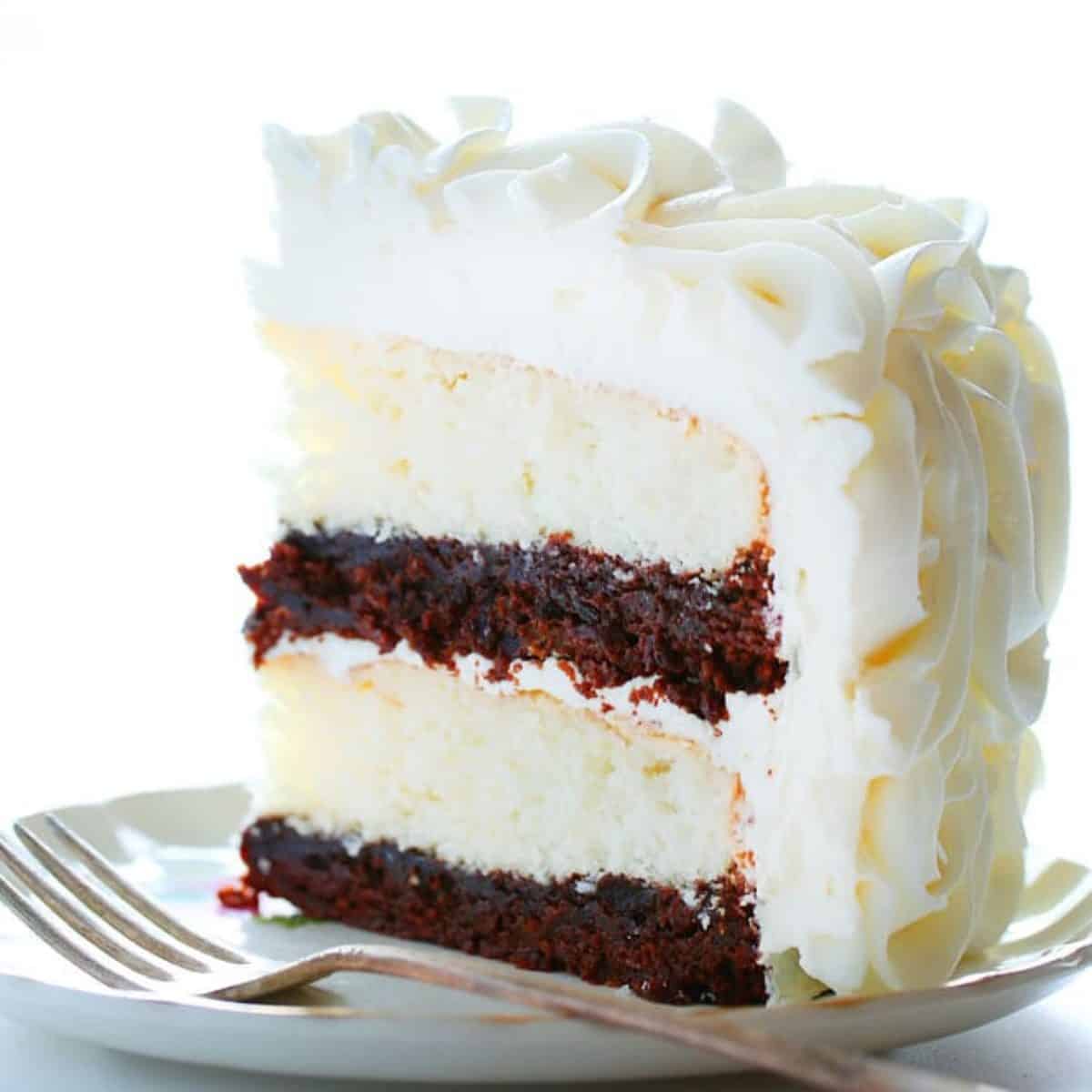 Stunning rosettes cover this flavorful cake... white cake layers complemented with rich fudgy brownie deliciousness!