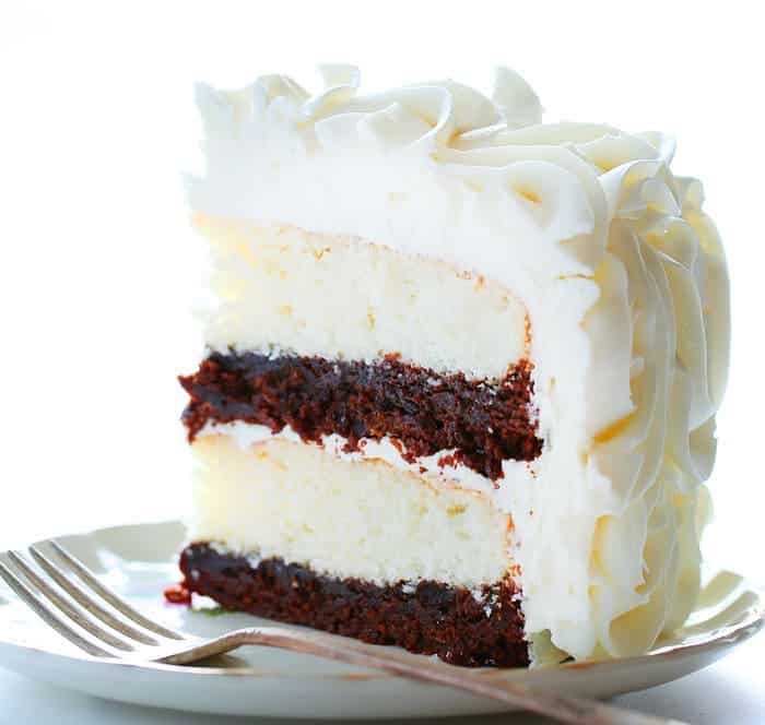 Stunning rosettes cover this flavorful cake... white cake layers complemented with rich fudgy brownie deliciousness!