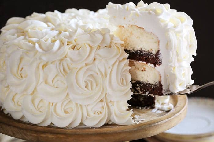 Stunning rosettes cover this flavorful cake... white cake layers complemented with rich fudgey brownie deliciousness!