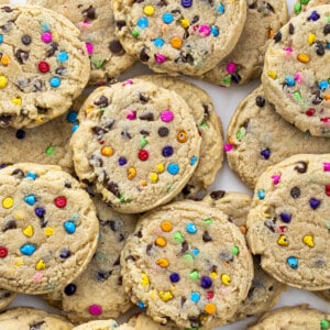 Rainbow Chip Cookies on a White Counter from Overhead. Baking, Cookies, Cookie Recipes, Dessert, Rainbow Chip, Rainbow Cookies, Rainbow Chip Chocolate Chip Cookies, Soft Cookies, Chewy Cookies, Cookie Dough, i am baker, iambaker