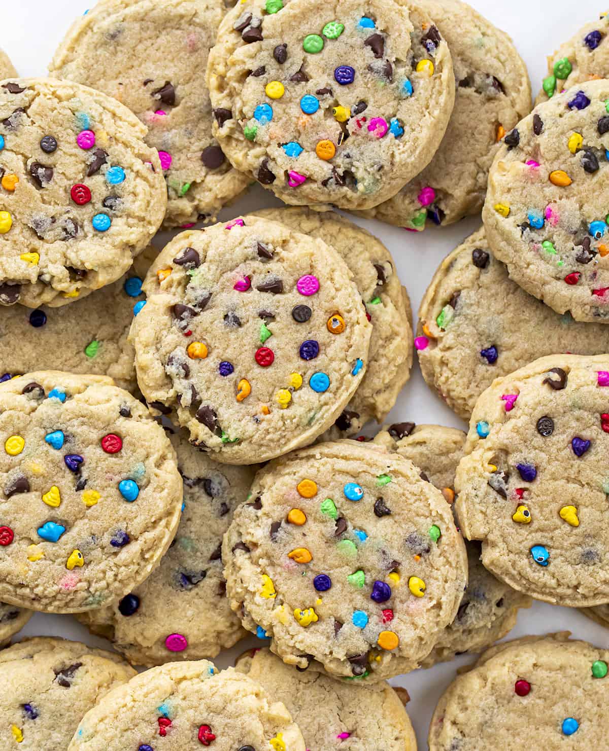 Rainbow Chip Cookies on a White Counter from Overhead. Baking, Cookies, Cookie Recipes, Dessert, Rainbow Chip, Rainbow Cookies, Rainbow Chip Chocolate Chip Cookies, Soft Cookies, Chewy Cookies, Cookie Dough, i am baker, iambaker