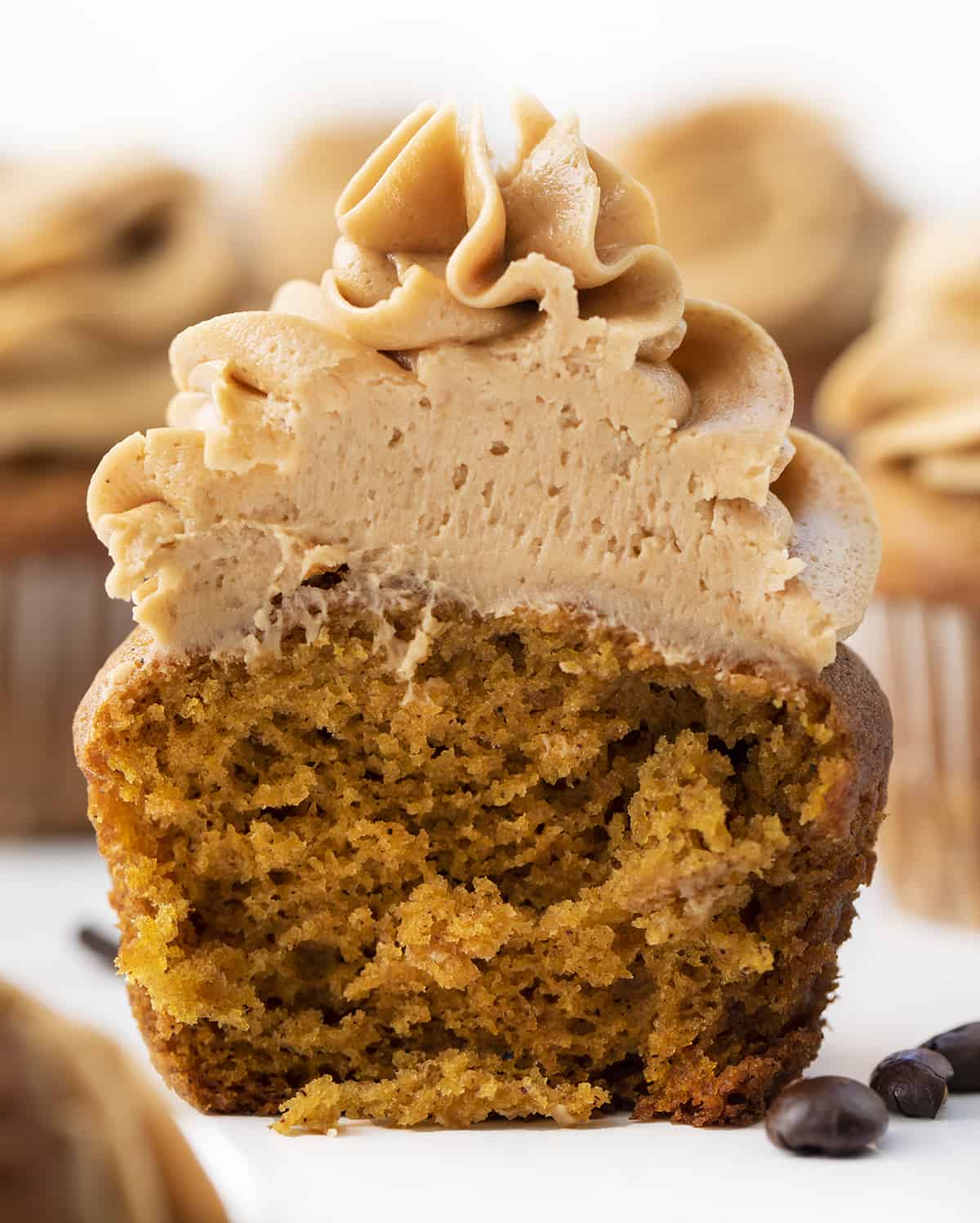 Cut into Pumpkin Spice Latte Cupcake Showing Tender Crumb. Cupcakes, Baking, Decorated Cupcakes, Frosted Cupcakes, Pumpkin Spice Cupcakes, Coffee Frosting, Dessert, Holiday Desserts, Christmas Dessert, Thanksgiving Desserts, Thanksgiving Cupcakes, Starbucks Cupcakes, i am baker, iambaker