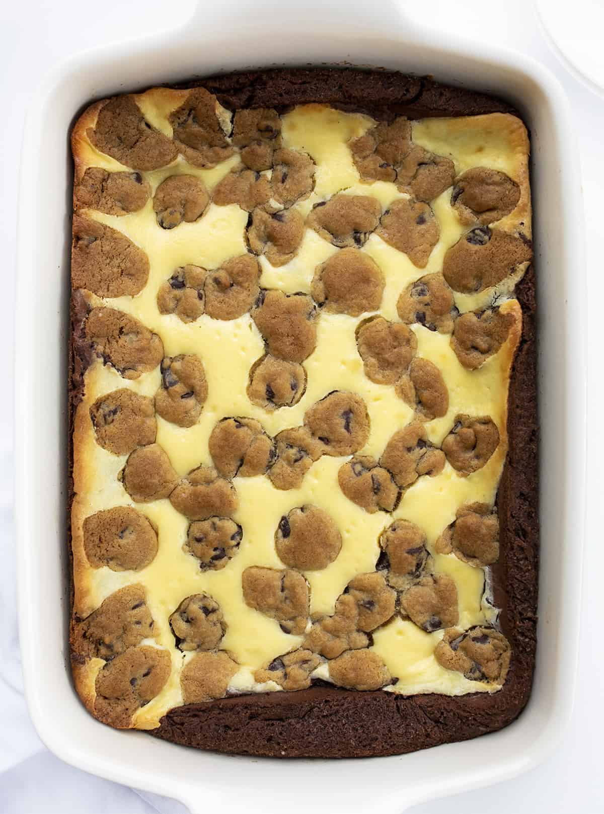 Chocolate Chip Cookie Cheesecake Brownies in a White Dish from Overhead