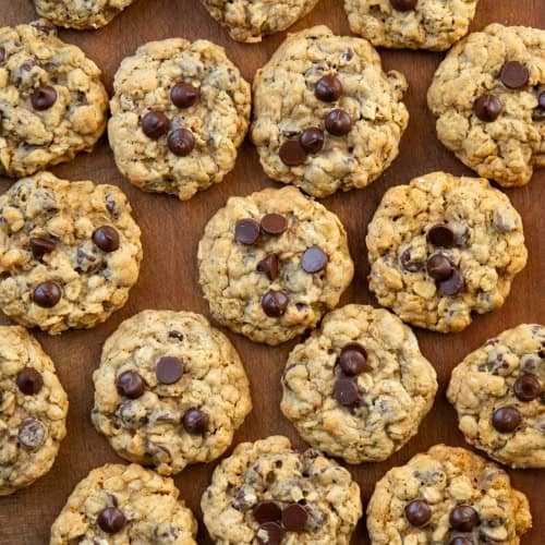 Oatmeal Chocolate Chip Cookies laid out on a wooden table from overhead.