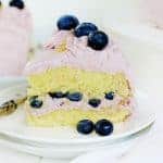 Slice of lemon layer cake with blueberry buttercream.
