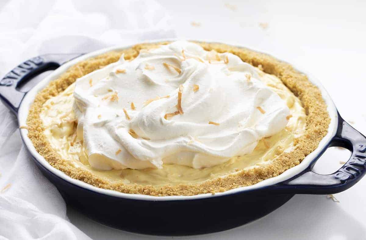 Easy Coconut Cream Pie in a Blue Staub Pie Dish on White Counter