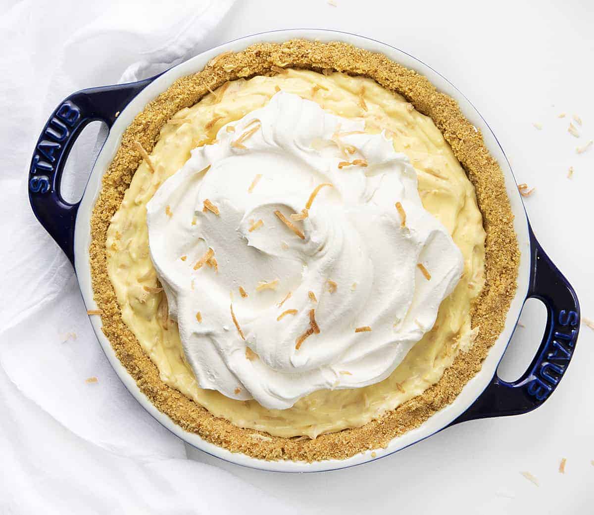 Overhead View of Coconut Cream Pie in Blue Pie Pan on White Counter