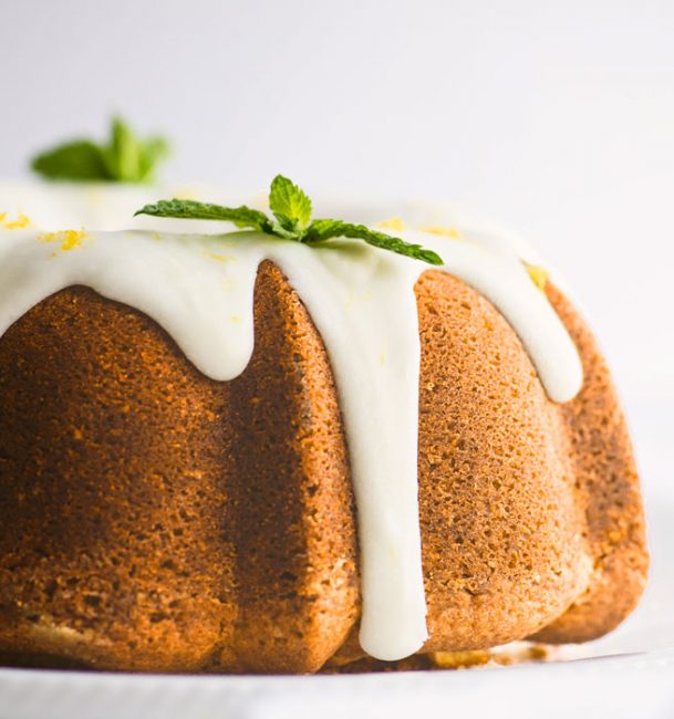 Lemon Bundt Cake on Cake Stand with Icing Drizzling