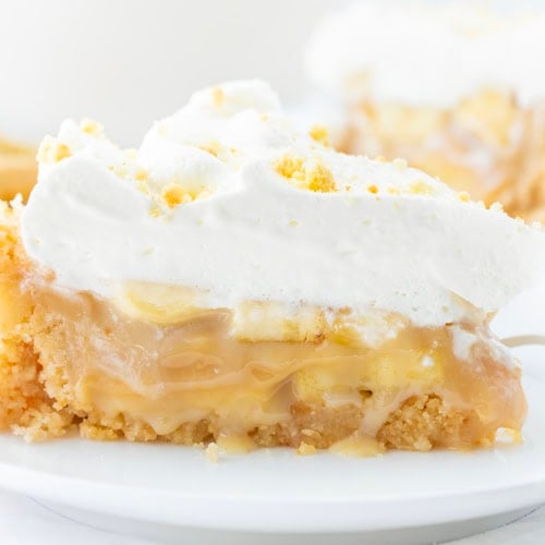 Piece of Banoffee Pie on a White Plate on a White Background.