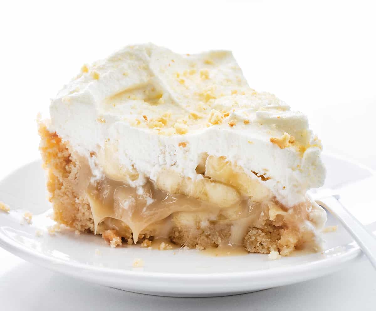 Piece of Banoffee Pie on a White Plate on a White Background. 