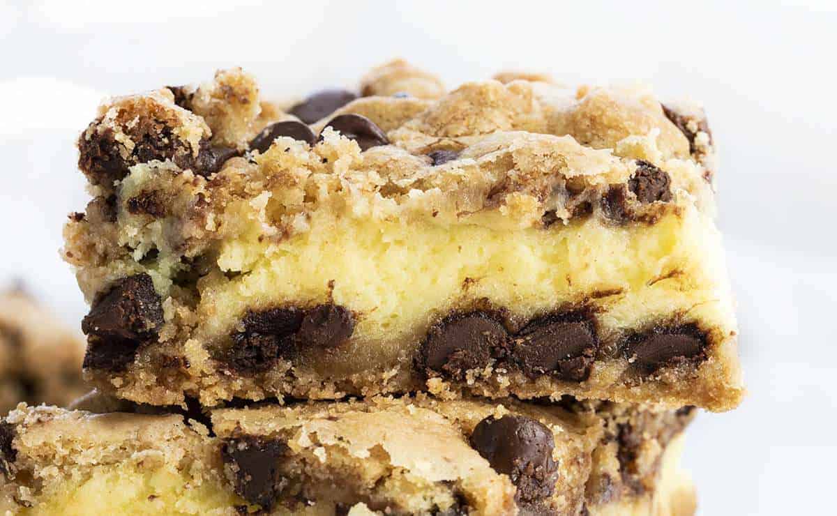 Chocolate Chip Cheesecake Bars Stacked and Showing a Very Close View of Top Bar