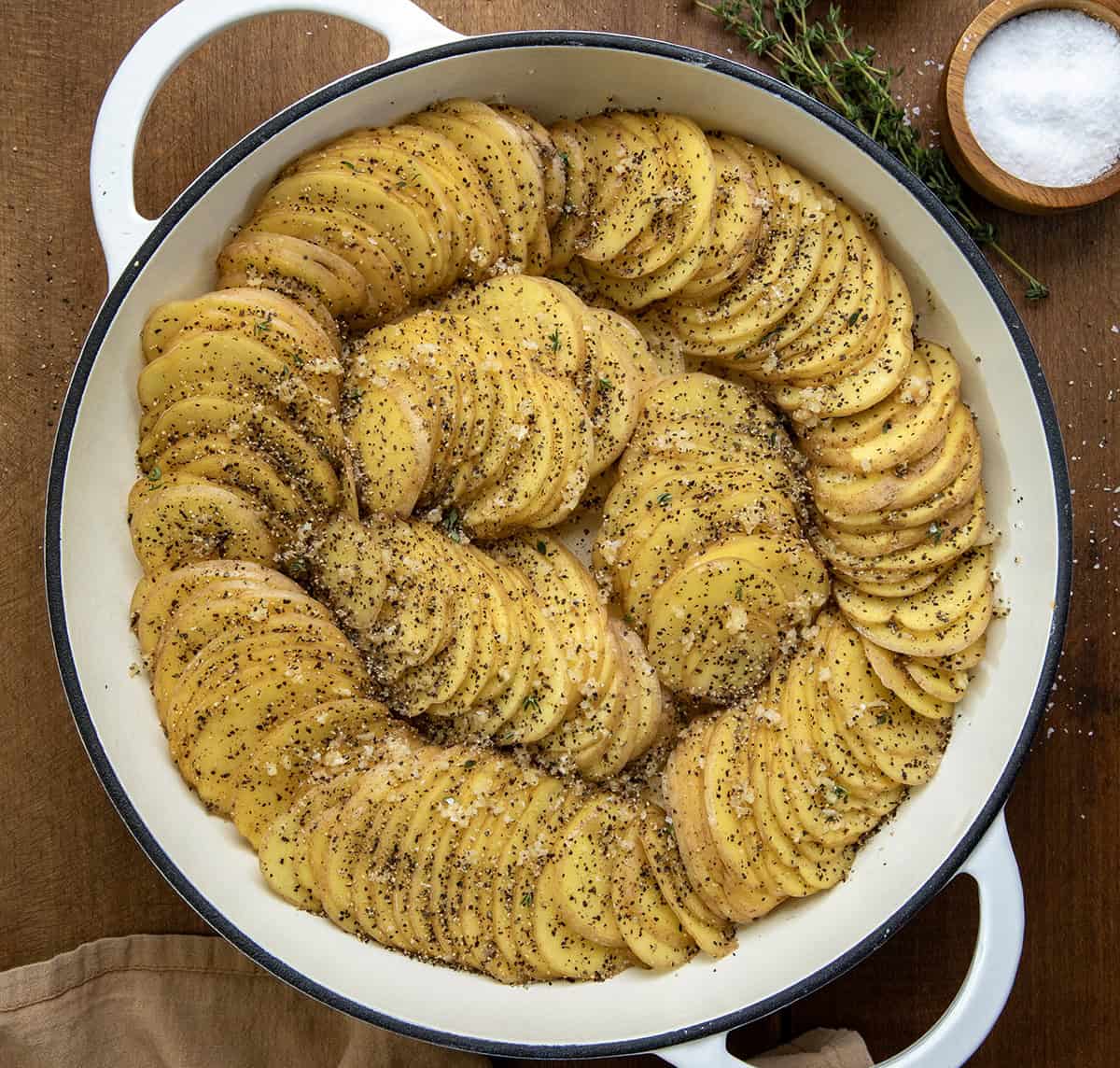These Gruyere Scalloped Potatoes are a definite crowd pleaser! Loads of glorious gruyere cheese melting into thinly sliced Yukon gold potatoes and covered in bacon and thyme! Gruyere Scalloped Potatoes before being baked.