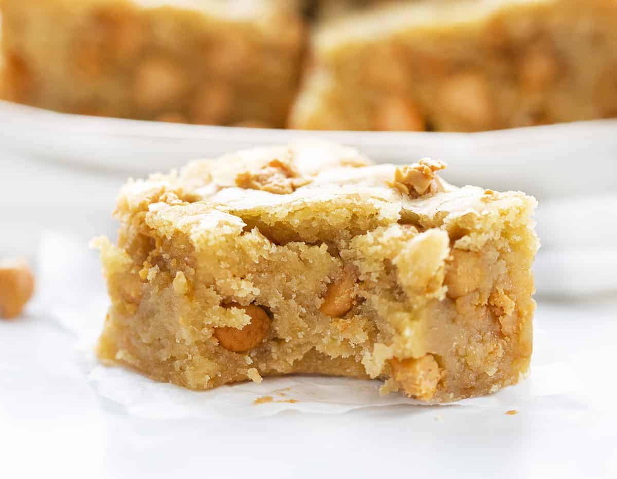 One Blondie with Bite Taken Out on White Counter with Blondies in Background