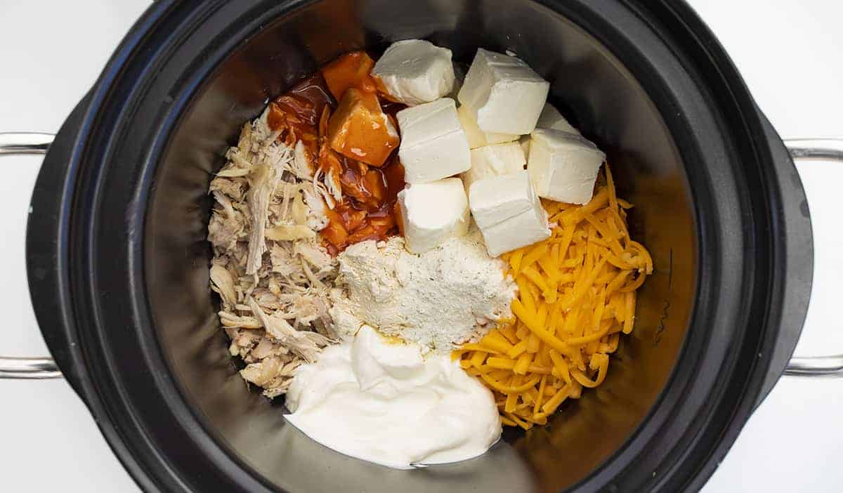 Crockpot with Ingredients for Buffalo Chicken Dip 